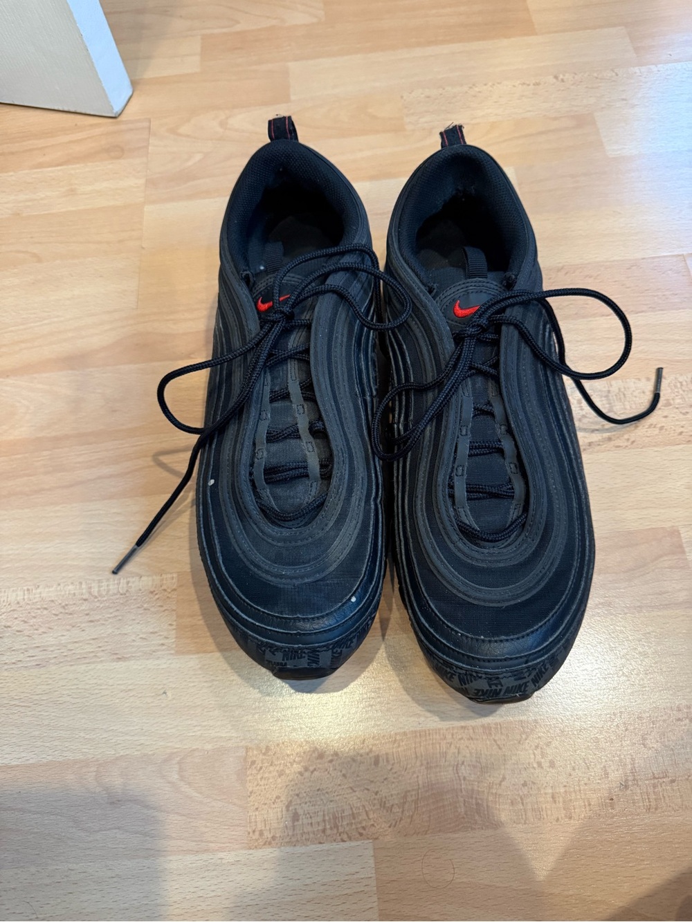 Nike Men’s Black Sneakers with Red Swoosh Accent